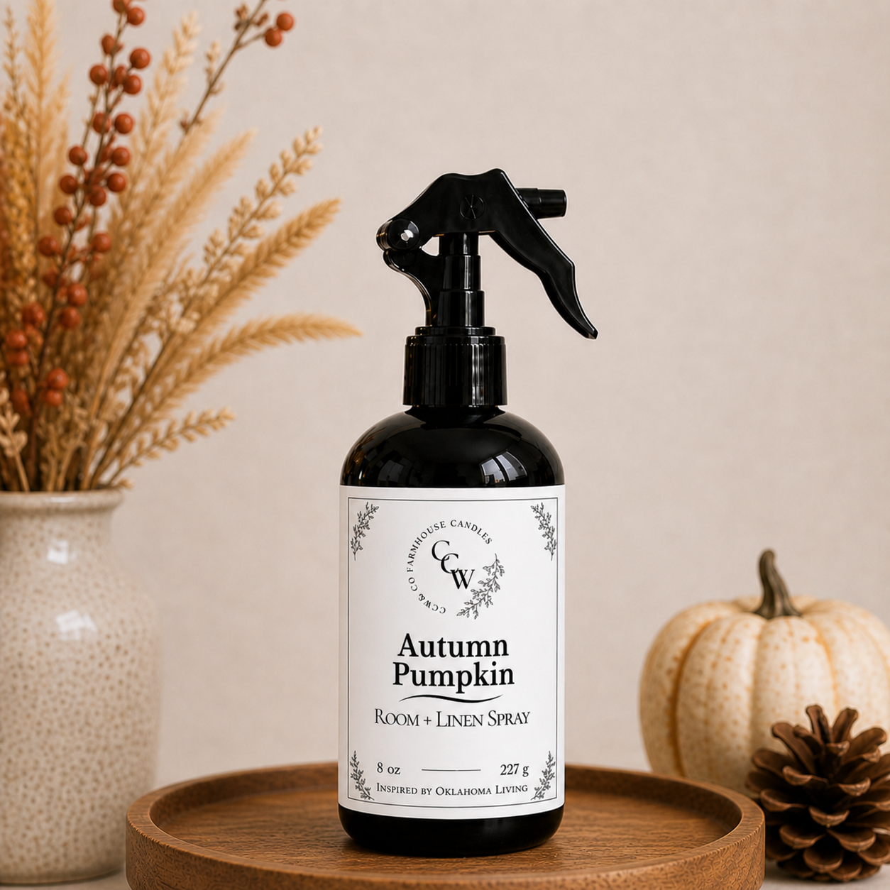 Autumn Pumpkin room and linen spray bottle on wooden tray with fall decor and neutral background