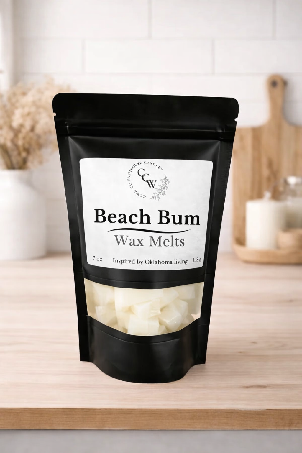 Black resealable pouch of Beach Bum wax melts by CCW & Co Farmhouse Candles, featuring a white label and clear window showing hand-poured wax melts, styled on a neutral kitchen countertop.