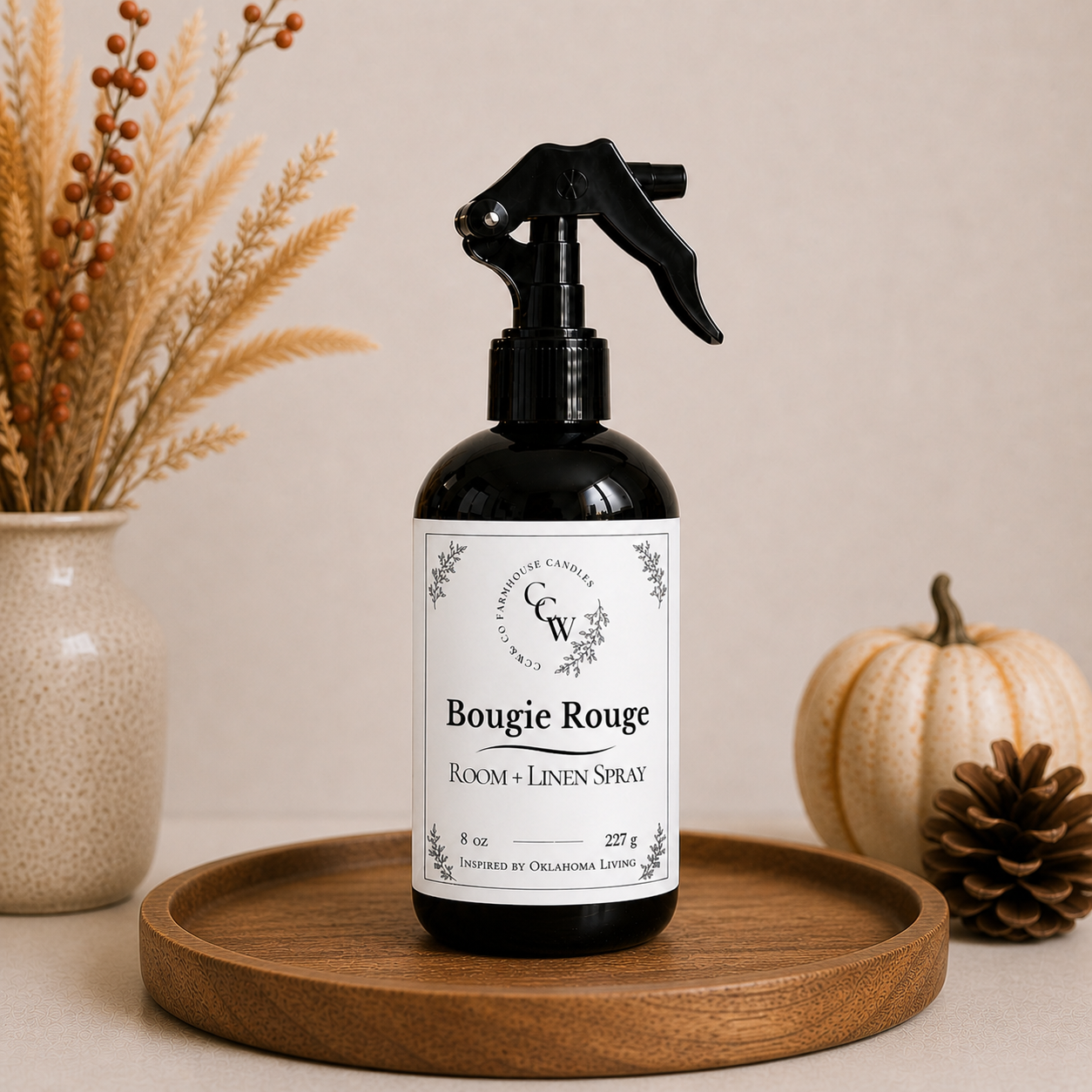 Bougie Rouge room and linen spray bottle on wooden tray with fall decor and neutral background