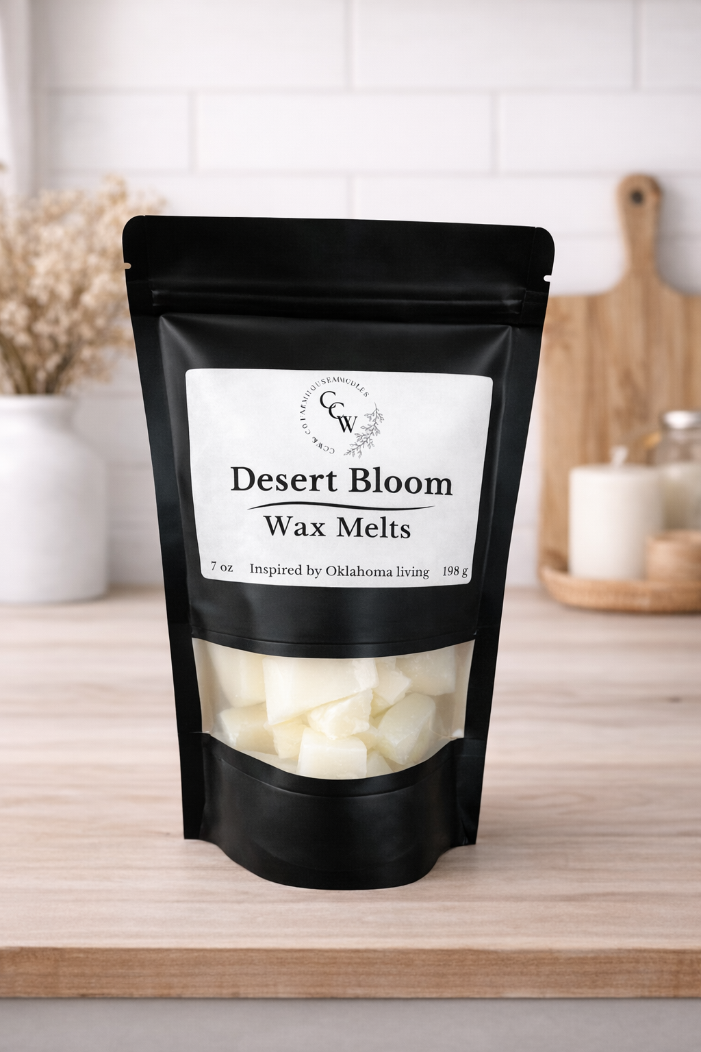 Black resealable pouch of Desert Bloom wax melts by CCW & Co Farmhouse Candles, featuring a white label and clear window showing hand-poured wax melts, styled on a neutral kitchen countertop.