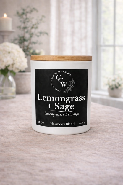 Lemongrass + Sage candle by CCW & Co Farmhouse Candles in a white jar with wooden lid, styled on a neutral tabletop in soft natural light
