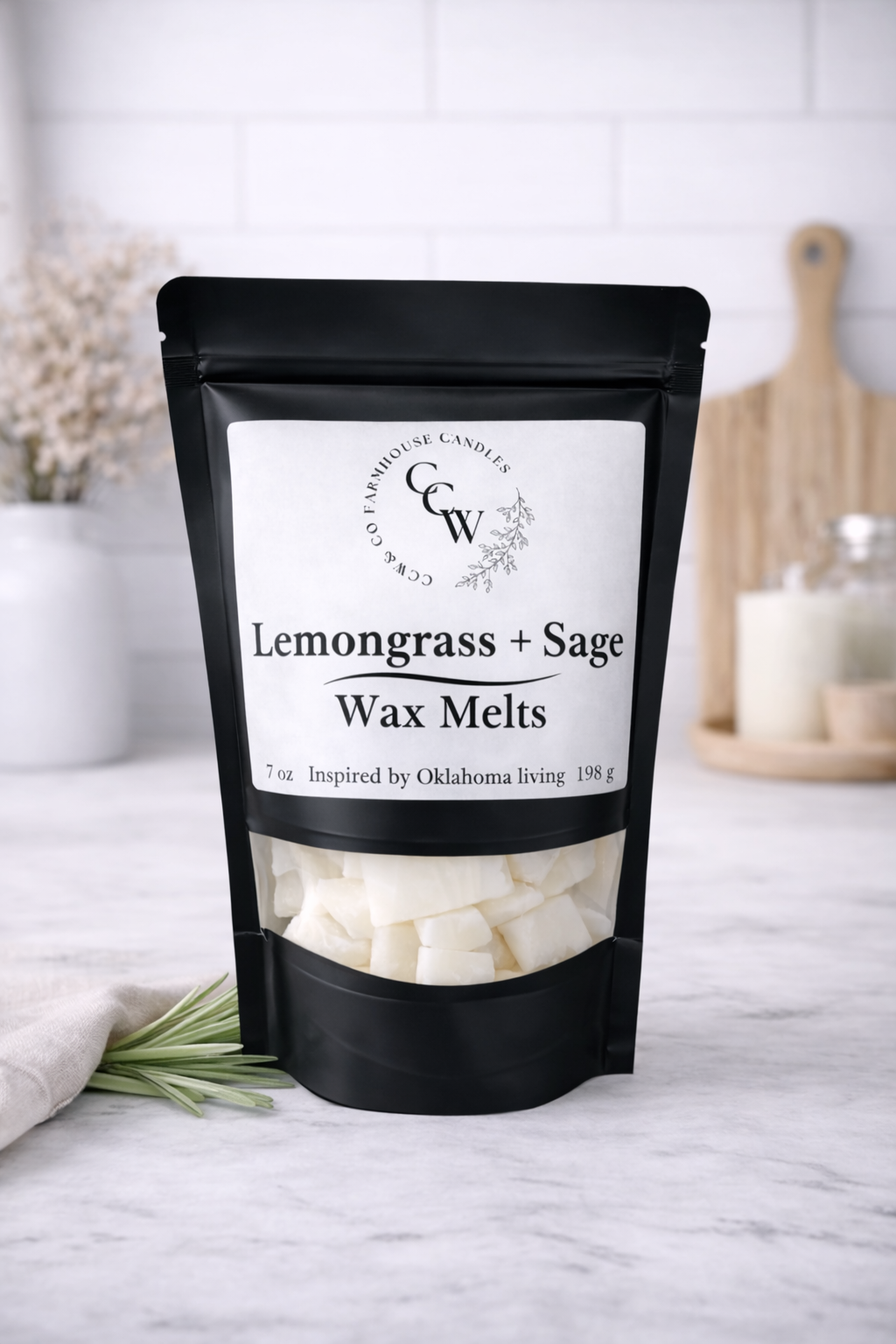 Black resealable pouch of Lemongrass + Sage wax melts by CCW & Co Farmhouse Candles, featuring a white label and clear window showing hand-poured wax melts, styled on a neutral kitchen countertop.