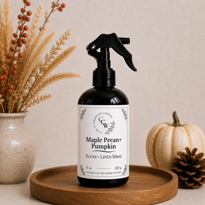 Maple Pecan + Pumpkin room and linen spray bottle on wooden tray with fall decor and neutral background
