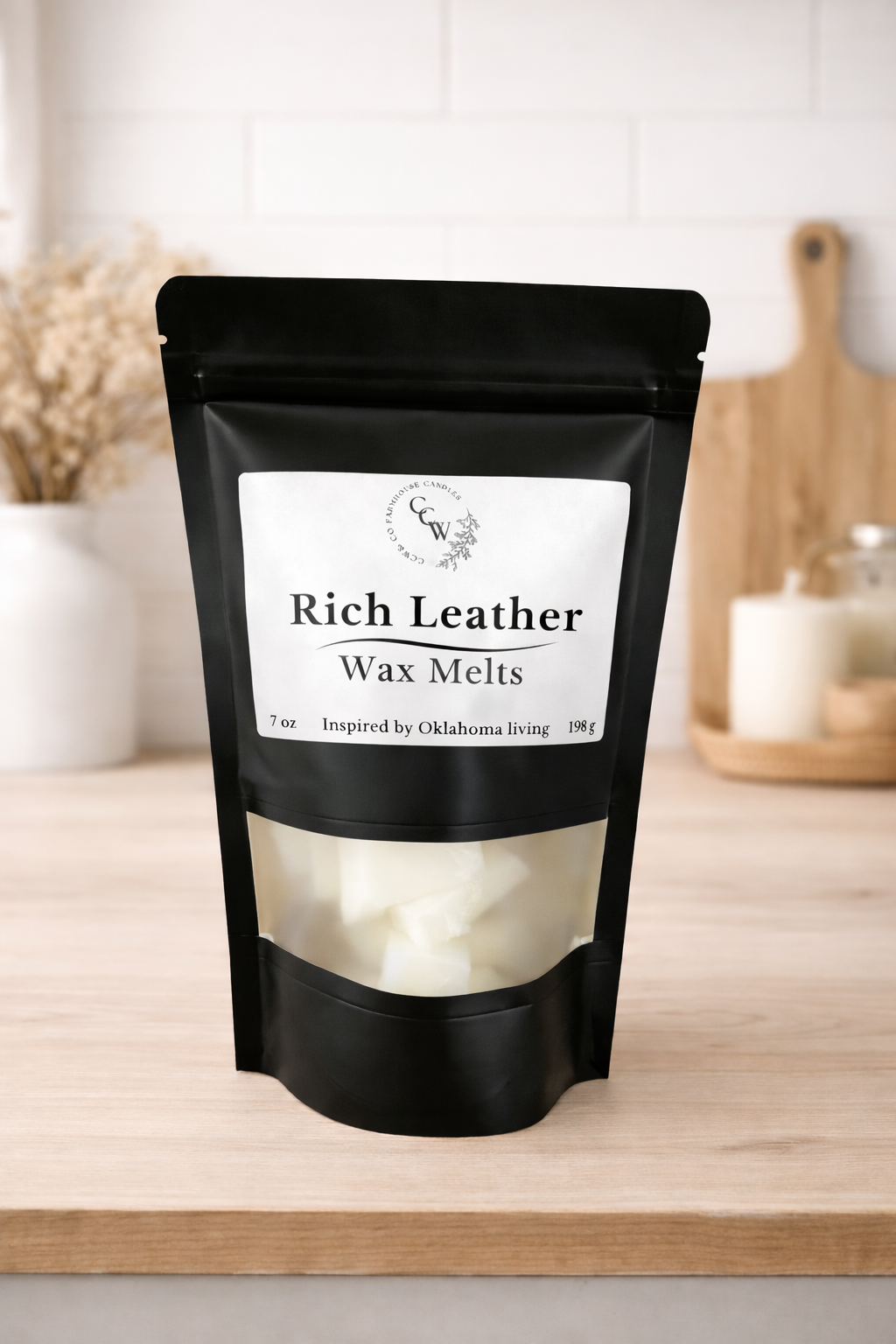 Black resealable pouch of Rich Leather wax melts by CCW & Co Farmhouse Candles, featuring a white label and clear window showing hand-poured wax melts, styled on a neutral kitchen countertop.