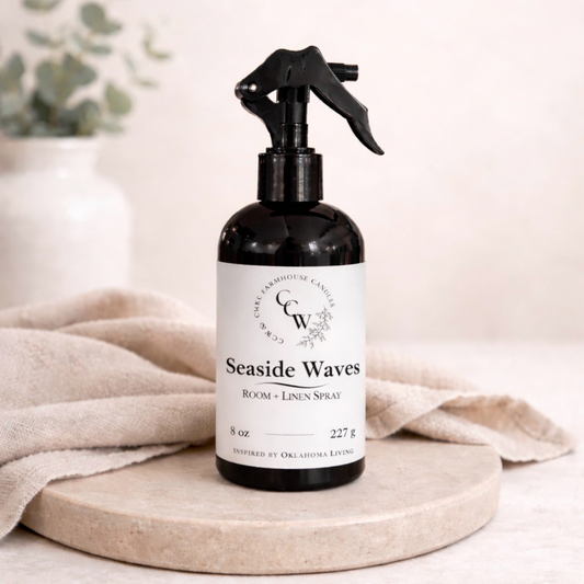 Black spray bottle labeled 'Seaside Waves' on a beige surface with a light background