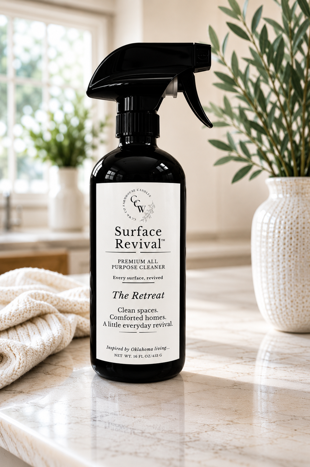 Surface Revival™ Premium All-Purpose Cleaner in The Retreat fragrance displayed on a marble countertop in a bright kitchen.