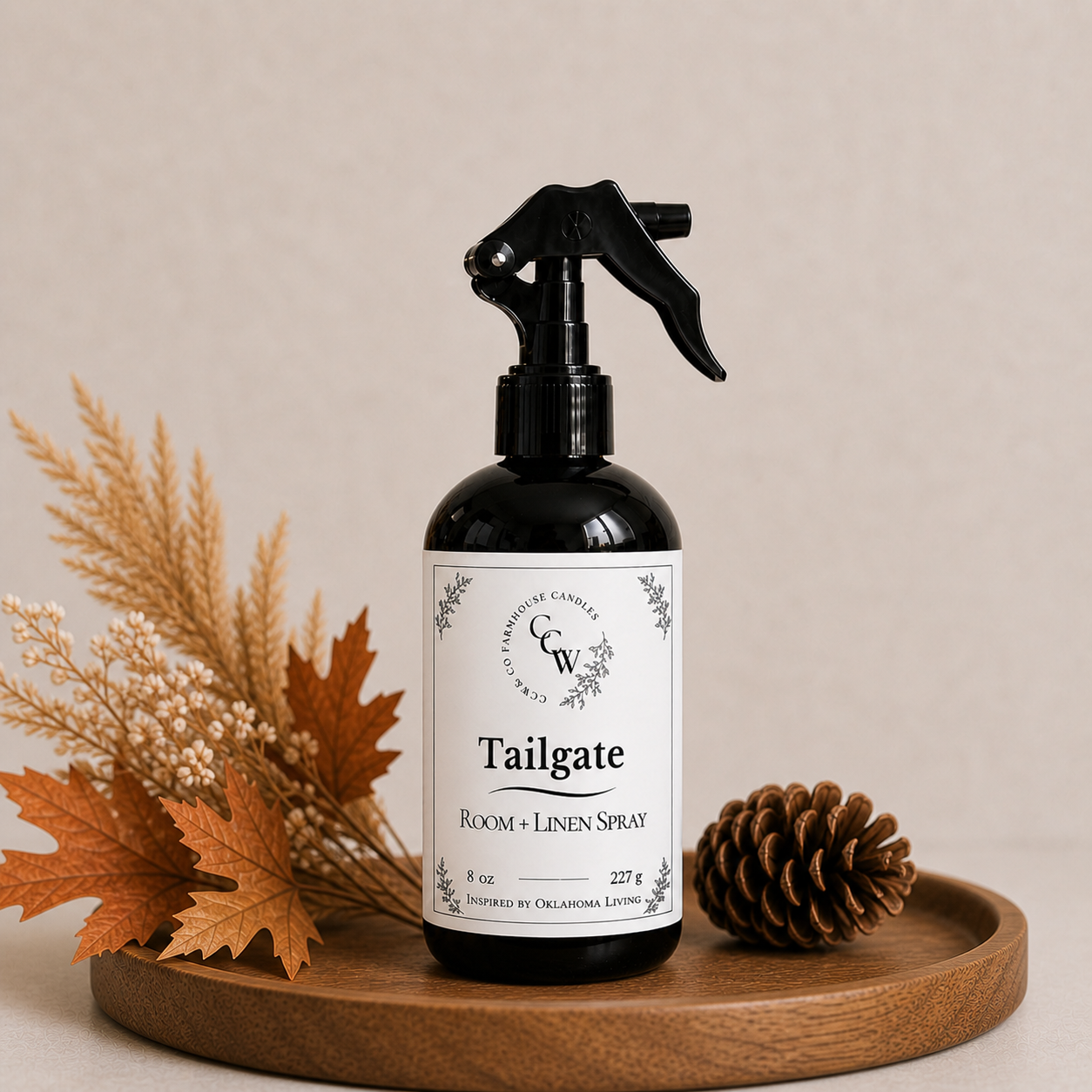 Tailgate room and linen spray bottle on wooden tray with fall decor and neutral background