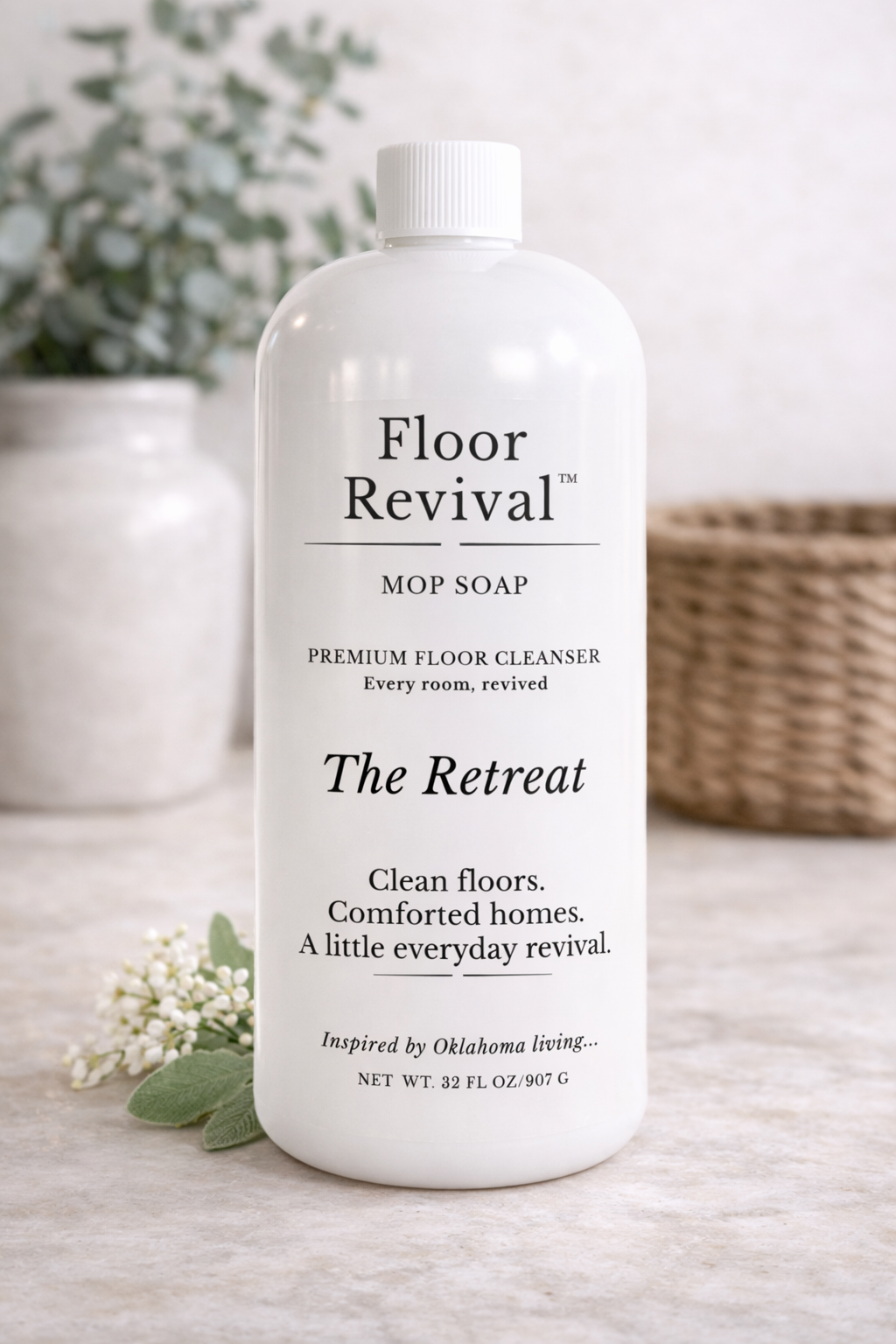 The Retreat Floor Revival mop soap bottle on neutral countertop – luxury home floor cleaner inspired by Oklahoma living.