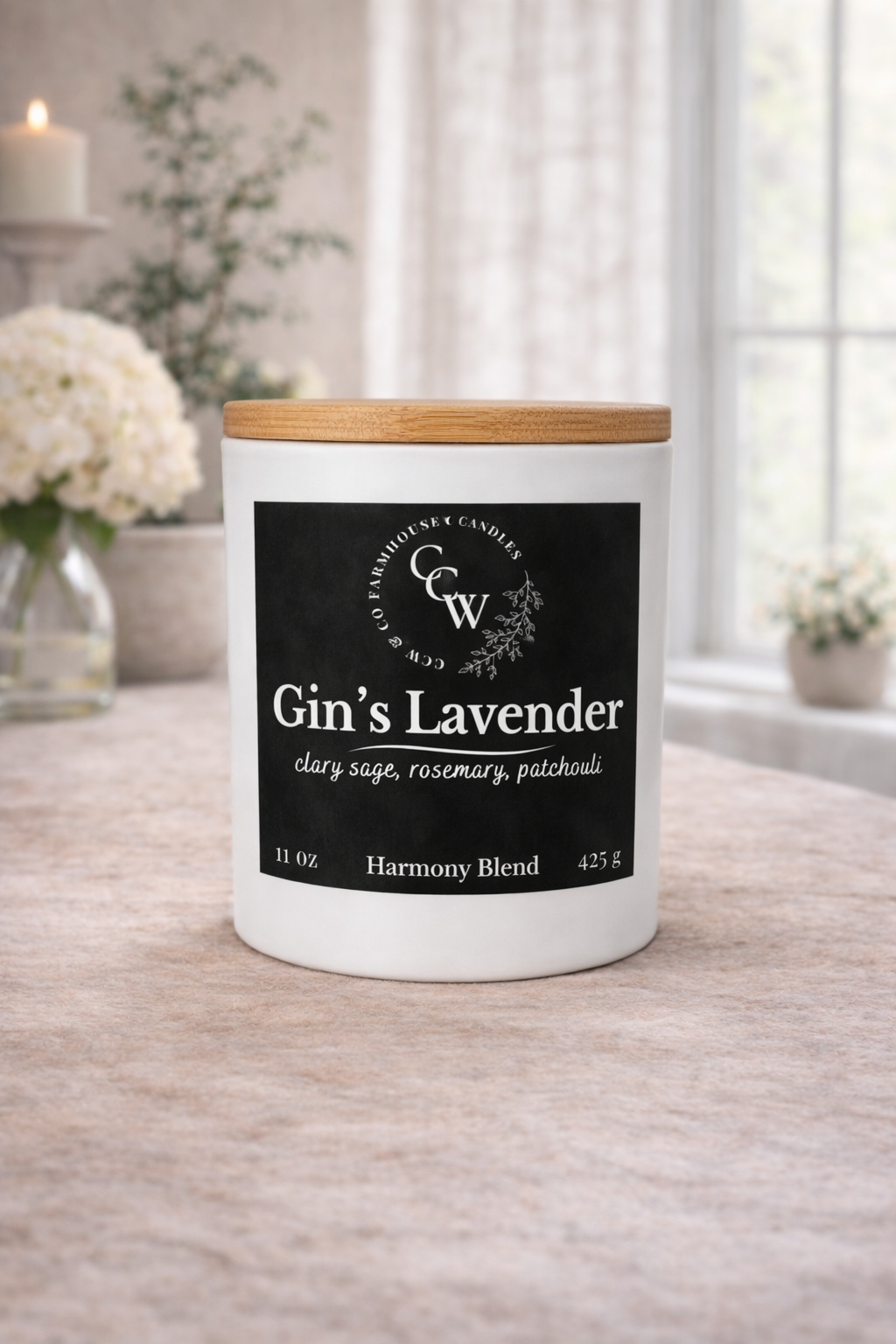 Gin’s Lavender candle by CCW & Co Farmhouse Candles in a white jar with wooden lid, styled on a neutral tabletop in soft natural light